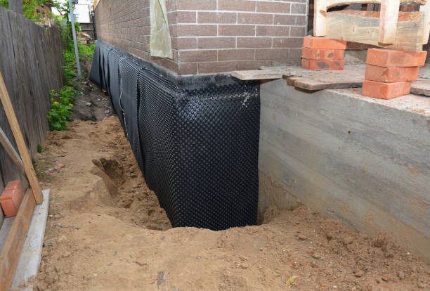 SJ Waterproofing Pros technician performing targeted Waterproofing assessment in Helenville, WI